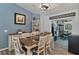 A stylish dining room with wainscoting and an open view into the home's eat in kitchen at 9 Logan St, Port Charlotte, FL 33954