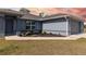 Close-up of front of home, showing manicured landscaping around the base of the house at 9 Logan St, Port Charlotte, FL 33954