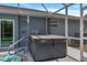 Enjoy outdoor living with a hot tub located on the patio, enclosed within a screened lanai for privacy and comfort at 9 Logan St, Port Charlotte, FL 33954