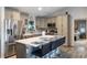 Open kitchen with large island, breakfast bar, stainless steel appliances and tiled backsplash at 9 Logan St, Port Charlotte, FL 33954