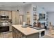 Open concept kitchen with island seating flowing to fireplace in living room at 9 Logan St, Port Charlotte, FL 33954