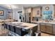 Bright kitchen with stainless steel appliances, island with bar seating, and granite countertops at 9 Logan St, Port Charlotte, FL 33954