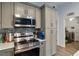 Modern kitchen featuring stainless steel appliances, sleek countertops, and tiled backsplash at 9 Logan St, Port Charlotte, FL 33954