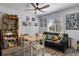Cozy living room featuring a ceiling fan, Green Bay decor, and natural light from the window at 9 Logan St, Port Charlotte, FL 33954