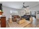 Comfortable living room with plush seating, a ceiling fan, and light, wood-look flooring at 9 Logan St, Port Charlotte, FL 33954