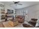 Comfortable living room with stylish seating, and marble fireplace detail, and a modern ceiling fan at 9 Logan St, Port Charlotte, FL 33954