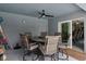 Covered patio showcases a ceiling fan, outdoor dining set, and convenient access to interior space through sliding glass doors at 9 Logan St, Port Charlotte, FL 33954