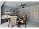 Covered patio with outdoor dining set, television, and outdoor grill, perfect for entertaining and relaxation at 9 Logan St, Port Charlotte, FL 33954