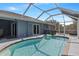 Enjoy a sparkling pool with a hot tub, all under a screened enclosure for year-round enjoyment and privacy at 9 Logan St, Port Charlotte, FL 33954