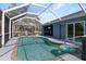 Relax by the sparkling pool, surrounded by a screened enclosure, complete with a hot tub and outdoor seating areas at 9 Logan St, Port Charlotte, FL 33954