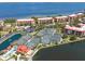 An aerial view showcases condo buildings, tennis courts, a pool, and a scenic waterfront in the community at 91 Vivante Blvd # 402/9142, Punta Gorda, FL 33950