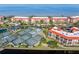 Aerial shot of lakeside condo community featuring tennis courts, parking, and waterfront views at 91 Vivante Blvd # 402/9142, Punta Gorda, FL 33950