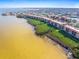 An aerial view displays the condo community along the waterfront, with lush greenery and scenic views at 91 Vivante Blvd # 402/9142, Punta Gorda, FL 33950