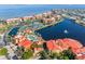 A bird's eye view highlights waterways, a pool, tennis courts, and condominiums within the Vivante Community at 91 Vivante Blvd # 402/9142, Punta Gorda, FL 33950
