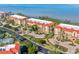 Aerial view of condo buildings featuring well maintained landscaping, tennis courts, and waterfront views at 91 Vivante Blvd # 402/9142, Punta Gorda, FL 33950