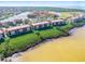 Panoramic aerial shot of resort condos near the water, showcasing vibrant community and scenic surroundings at 91 Vivante Blvd # 402/9142, Punta Gorda, FL 33950