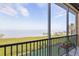 Balcony view overlooking lush greenery and open water, providing a serene and relaxing outdoor space at 91 Vivante Blvd # 402/9142, Punta Gorda, FL 33950