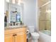 Bathroom featuring a granite countertop, a wood vanity, a toilet, and a glass-enclosed shower at 91 Vivante Blvd # 402/9142, Punta Gorda, FL 33950
