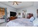 Bedroom featuring a large TV on a dark wood dresser and an outdoor seating area at 91 Vivante Blvd # 402/9142, Punta Gorda, FL 33950