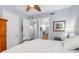 Bedroom featuring a view into the bathroom, wood furniture, and a ceiling fan at 91 Vivante Blvd # 402/9142, Punta Gorda, FL 33950
