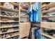 A walk-in closet featuring shelves with organized clothing and shoes, plus drawers at 91 Vivante Blvd # 402/9142, Punta Gorda, FL 33950