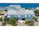 Exterior of Fisherman's Village, a blue building with shops, palm trees, and waterfront access at 91 Vivante Blvd # 402/9142, Punta Gorda, FL 33950