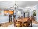 Dining area with hardwood floors, an island bar with leather stools, and a chandelier at 91 Vivante Blvd # 402/9142, Punta Gorda, FL 33950
