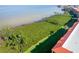 A scenic aerial view of lush green space between condos and waterfront, showcasing landscaping and building exterior at 91 Vivante Blvd # 402/9142, Punta Gorda, FL 33950