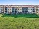 Beautiful low-rise condo exterior with balconies and ample parking, set against a green landscape at 91 Vivante Blvd # 402/9142, Punta Gorda, FL 33950