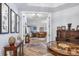 Elegant foyer with hardwood floors and decorative accents, leading to open-concept living and dining areas at 91 Vivante Blvd # 402/9142, Punta Gorda, FL 33950