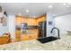 Modern kitchen with stainless steel appliances, wood cabinets and granite counters at 91 Vivante Blvd # 402/9142, Punta Gorda, FL 33950