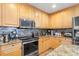 Kitchen with stainless steel oven and microwave and tan granite countertops at 91 Vivante Blvd # 402/9142, Punta Gorda, FL 33950