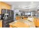 Open concept kitchen with tan granite countertops and stainless steel refrigerator at 91 Vivante Blvd # 402/9142, Punta Gorda, FL 33950