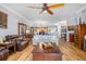 Spacious living room with hardwood floors, ceiling fan, and adjacent kitchen at 91 Vivante Blvd # 402/9142, Punta Gorda, FL 33950