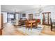 Open living space with hardwood floors, dining table, and access to outdoor balcony at 91 Vivante Blvd # 402/9142, Punta Gorda, FL 33950