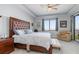 Well lit main bedroom with king bed, ceiling fan, and walk-out patio at 91 Vivante Blvd # 402/9142, Punta Gorda, FL 33950