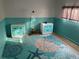 Bedroom with teal wainscoting, two dressers, and a sea-themed rug at 12077 Maryland Ave, Punta Gorda, FL 33955