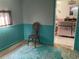 Bedroom with teal wainscoting, wood chair, and sea-themed rug at 12077 Maryland Ave, Punta Gorda, FL 33955