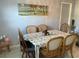 Bright dining area with table, chairs, and beach themed decor at 12077 Maryland Ave, Punta Gorda, FL 33955