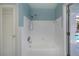 White tiled bathroom with shower/tub combo and pool view at 125 Ott Cir, Port Charlotte, FL 33952