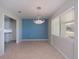 Dining room with a chandelier and view into kitchen at 125 Ott Cir, Port Charlotte, FL 33952