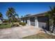 View of the home's exterior, highlighting the two-car garage at 125 Ott Cir, Port Charlotte, FL 33952