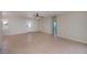 Open living room with tile floors and an interior door at 125 Ott Cir, Port Charlotte, FL 33952