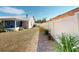 Home exterior with a vinyl fenced backyard featuring lush landscaping and lawn at 1311 Abscott St, Port Charlotte, FL 33952