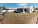 Exterior view of backyard and screened-in lanai with white fence in the background at 1311 Abscott St, Port Charlotte, FL 33952