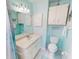 Clean bathroom features a white vanity, toilet, and shower/tub combination with a blue color scheme at 1311 Abscott St, Port Charlotte, FL 33952