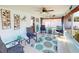 Light-filled Florida room featuring neutral tile flooring, comfortable seating, and decor at 1311 Abscott St, Port Charlotte, FL 33952