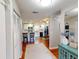 Inviting entry hallway leading to a kitchen with white cabinets, hardwood floors, and modern finishes at 1311 Abscott St, Port Charlotte, FL 33952