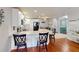 Kitchen featuring a breakfast bar, hardwood floors, stainless steel appliances and white subway tile backsplash at 1311 Abscott St, Port Charlotte, FL 33952