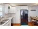 Bright kitchen featuring white cabinetry, granite countertops, subway tile backsplash and stainless steel refrigerator at 1311 Abscott St, Port Charlotte, FL 33952